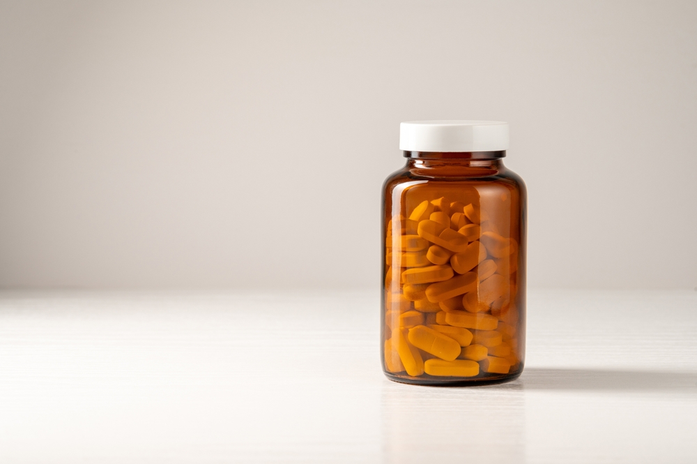 White pills in brown glass jar, food supplements, drugs, antibiotics.