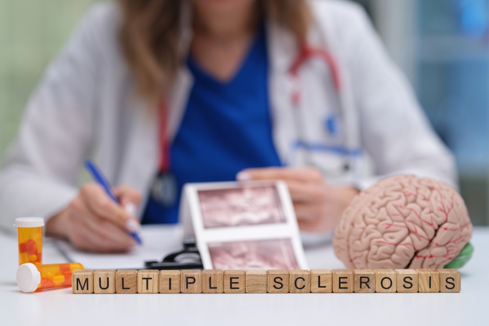 A healthcare professional is carefully analyzing medical images that are related to multiple sclerosis and its effects