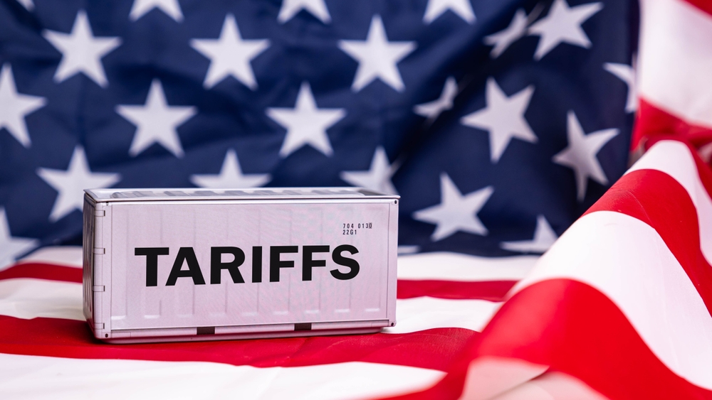 Container tariffs word on Flag of the United States of America background.
Tariff US trade war with Canada and Mexico.