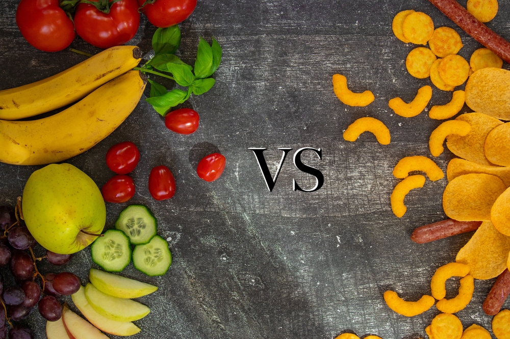 Healthy fruits and vegetables on one side and fast food, chips, and unhealthy snacks on the other. A visual representation of choices, healthy vs unhealthy, balance, and decision-making.