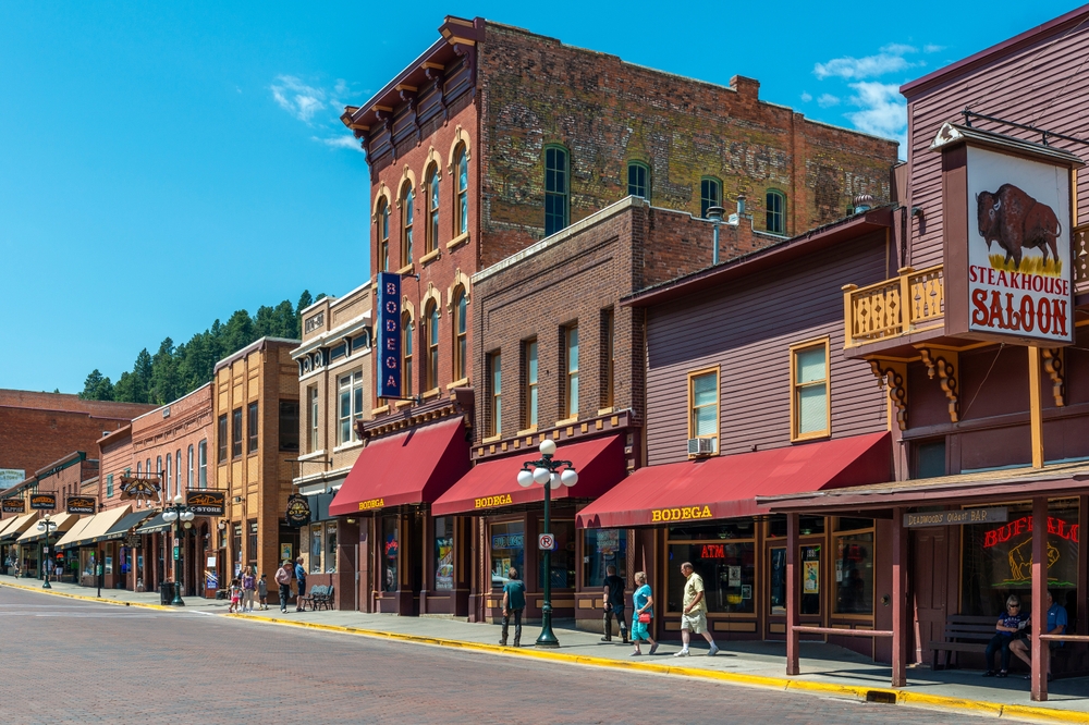 DEADWOOD, USA - JULY 18, 2017: Main street of Wild West town of Deadwood with restaurants, bars and people walking in summer, South Dakota.