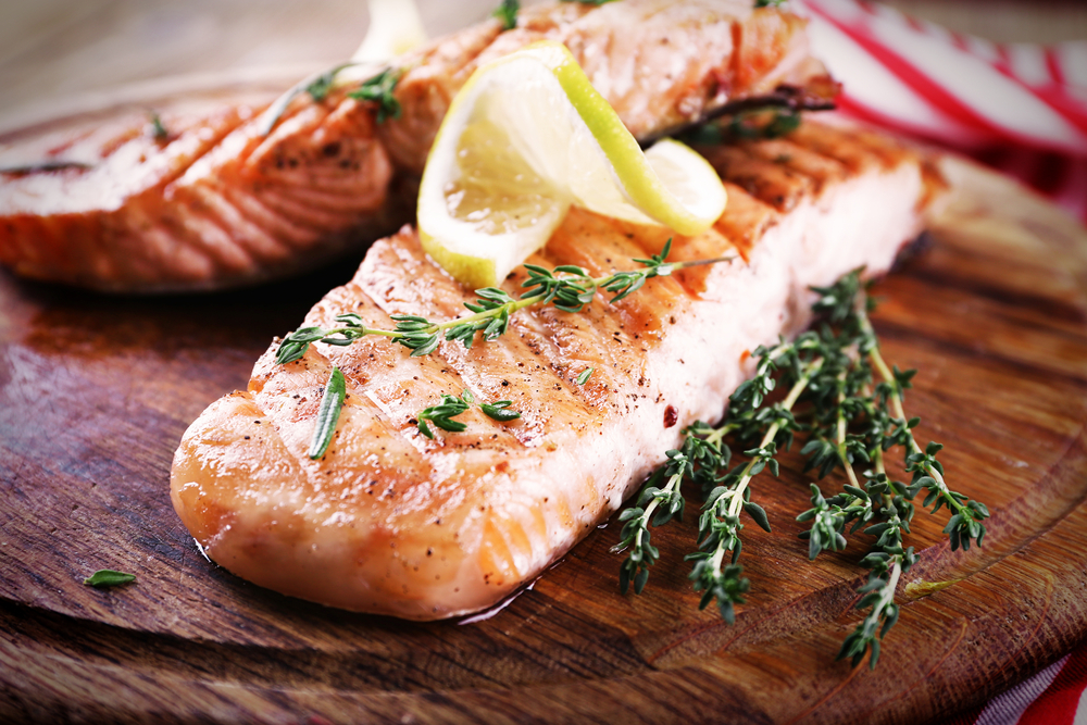 Grilled salmon on cutting board close-up