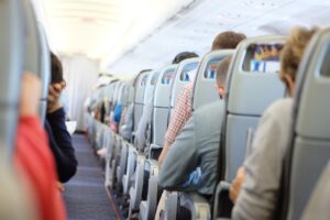 Airlines Initiate ‘Titanic’ Policy and Travelers Are Not Happy aisle in an airline jet