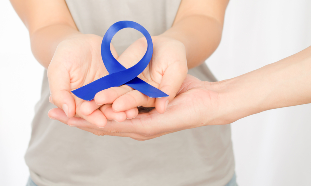 Blue ribbon in the hands of young, silk satin ribbon symbol