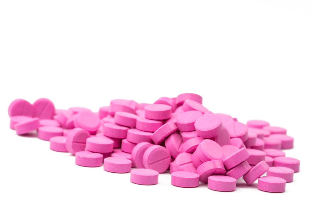 A bunch of warfarin pills pink talls on them white. Warfarin for the treatment of deep vein thrombosis. Anticoagulant medicine. Pharmaceutical drug product. Pharmaceutical industry. Anticoagulation.