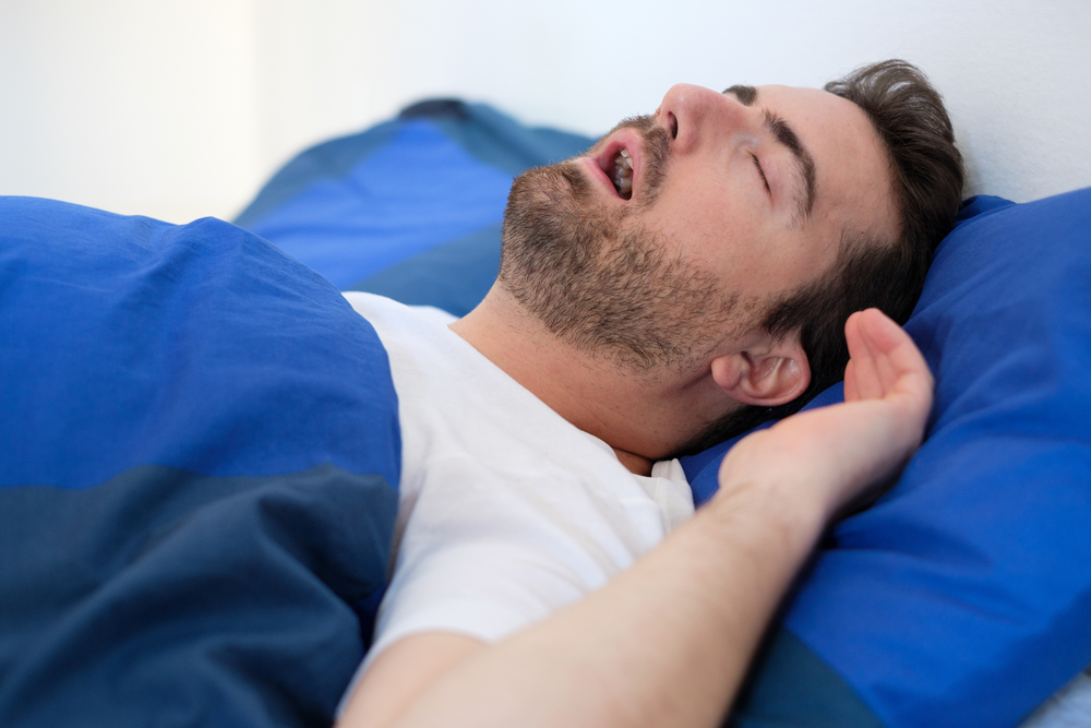 Face close up of snoring man because of hypopnea disorder