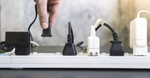 Person plugging into a power bar