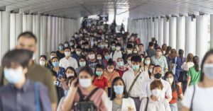 'The Big One’ Could Be Deadlier Than COVID, Expert Warns of 7million+ Death Toll large crowd of people all wearing PPE face masks. Pandemic concept