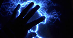 hand with waves of electricity around it