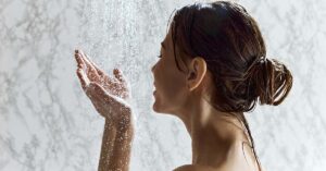 Inside the ‘Everything Shower’: The Viral Self-Care Habit Sweeping TikTok Woman enjoying a hot shower