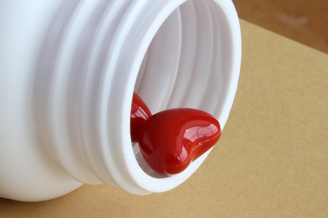 a heart-shaped capsule in a bottle
