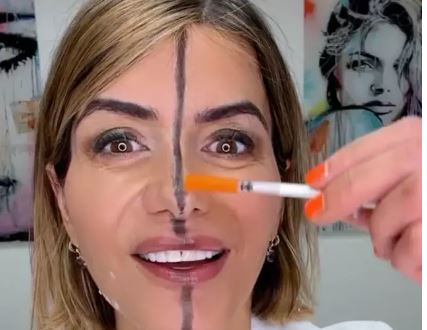 A woman with a line drawn down the middle of her face and botoxed on one side. 