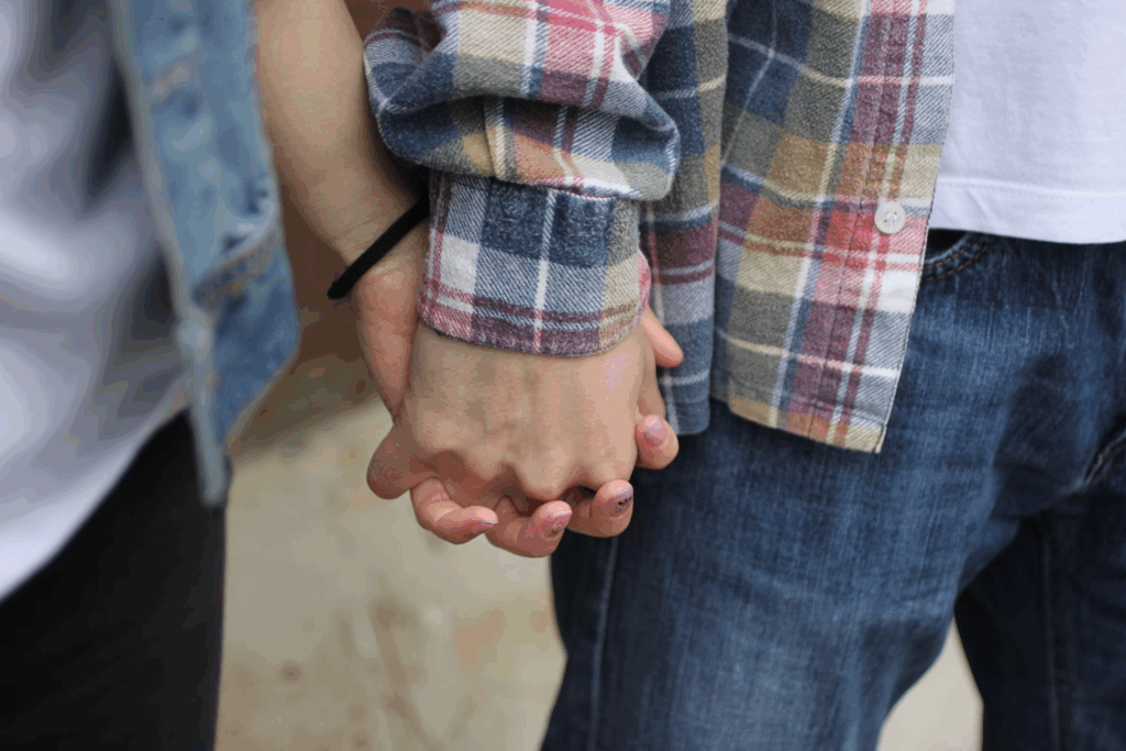 couple in long sleeved shirts holding hands
