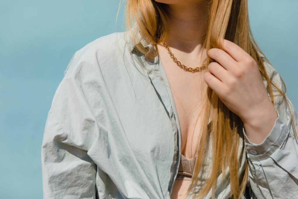 Woman in Bray Button Up Shirt Wearing a Gold Necklace