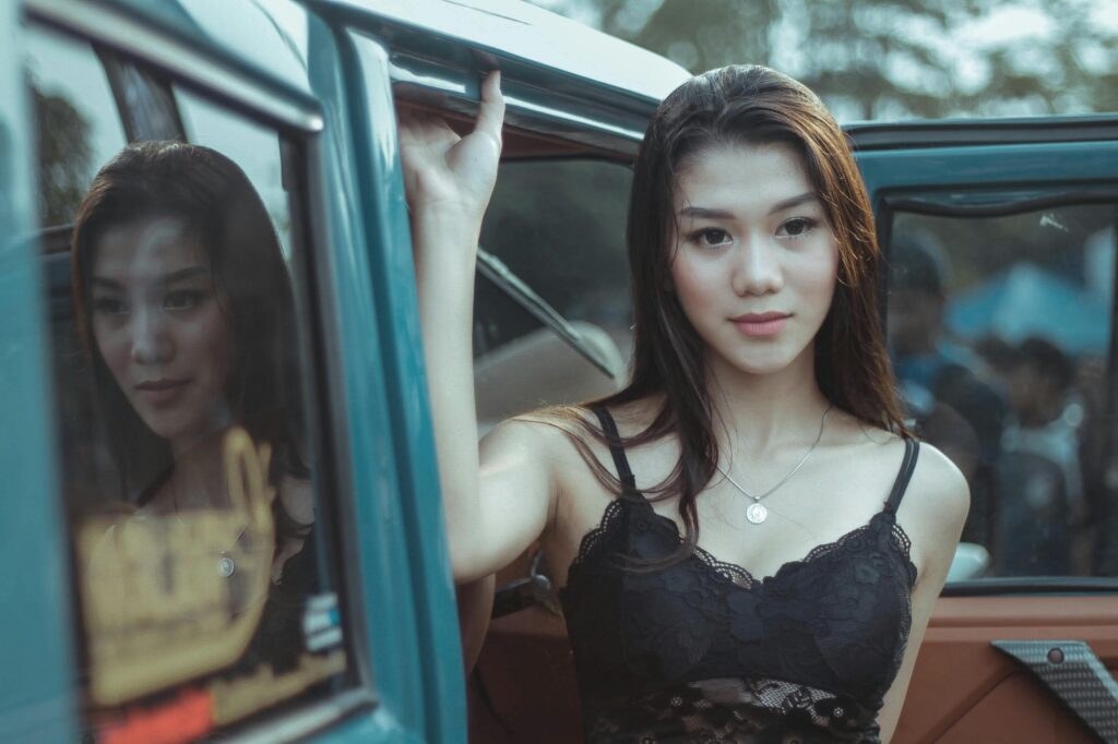 Woman Wearing Lace Tank Top Holding a Car Door