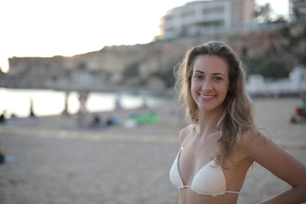 Woman with small breasts in White Bra Smiling