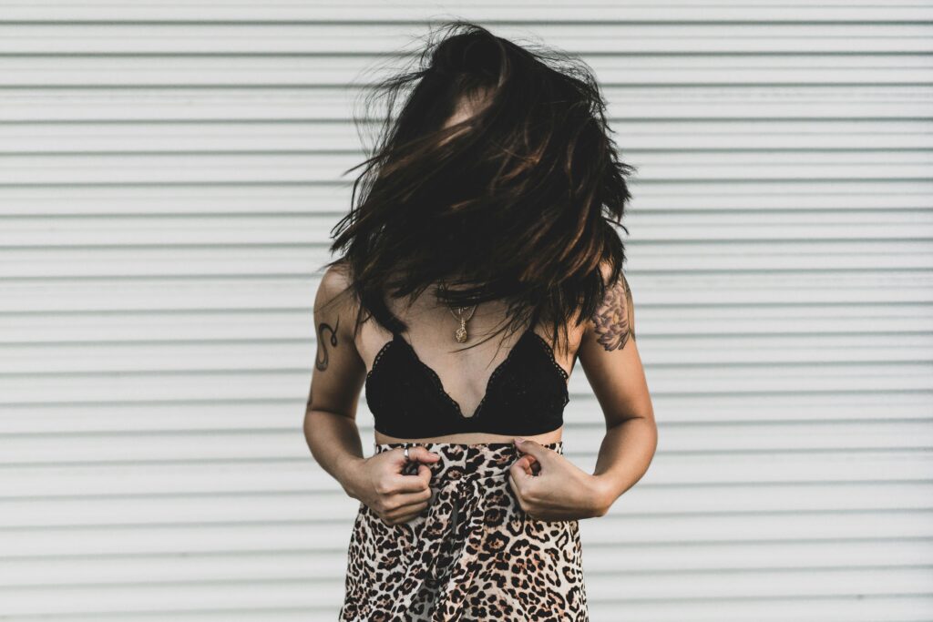 Woman Wearing Black Bra Covering Face With Hair
