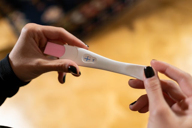 woman holding a pregnancy test