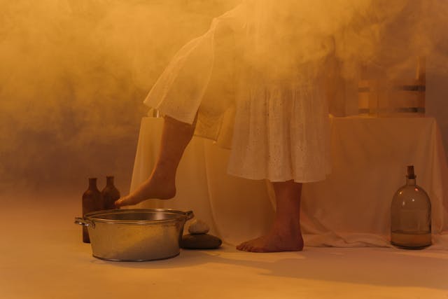 a woman taking a foot bath