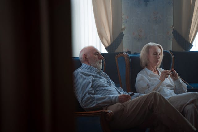 an elderly couple watching television