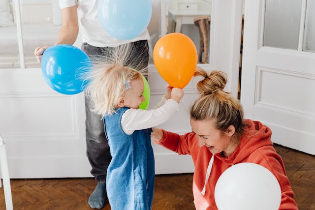 a family playing with static balloons