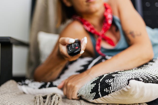 a woman holding a remote control