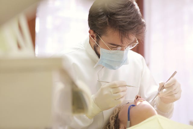 a patient having her mouth checked by a dentist