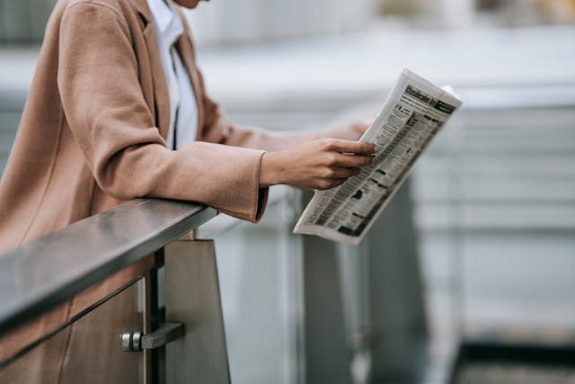 A woman reading a newspaper