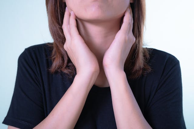 a woman holding her neck