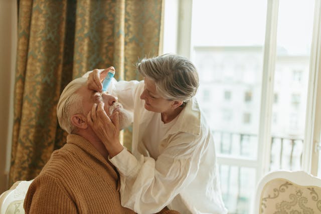 a man receiving eye drops