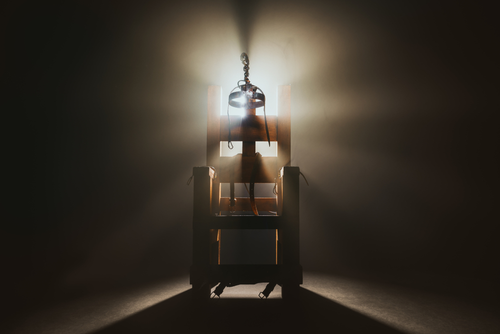 High resolution photo of a scale model of an electric chair on a smoke-black backgorund