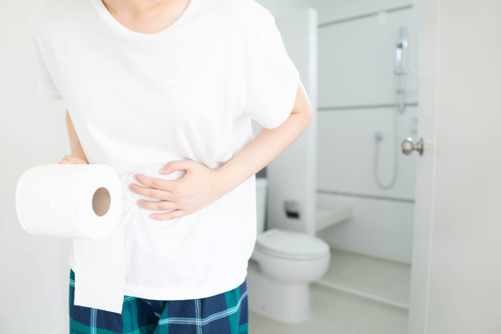A young woman suffered abdominal pain and holding parts of the private sector in front of the toilet home. The idea of ​​constipation, diarrhea, hemorrhoid, food poisoning or IBS. Health care.