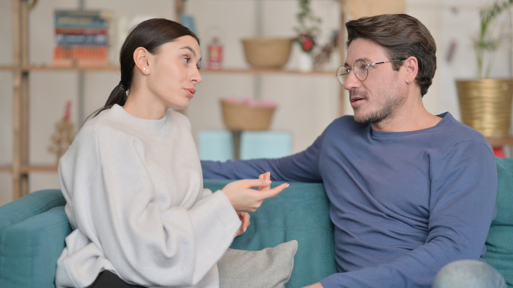 Attractive Mixed Race Couple having Conversation at Home 