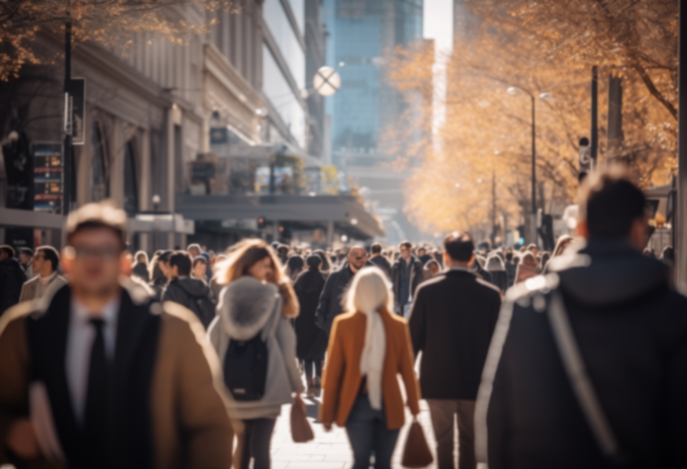 Anonymous crowd of people walking street. Crowds and citizens shoppers walking on a busy street blurred.