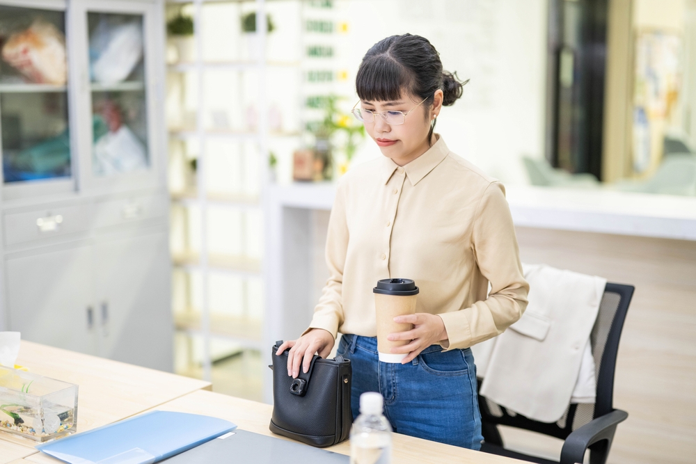 White-collar worker carrying coffee to work in the office in the morning