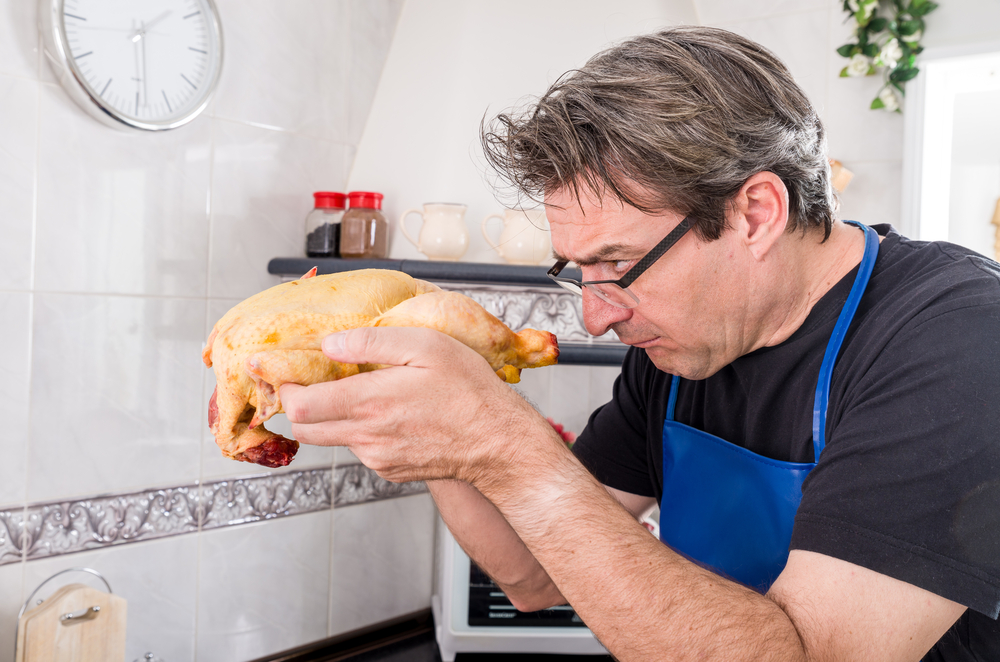 First time a guy faces a raw chicken in the kitchen