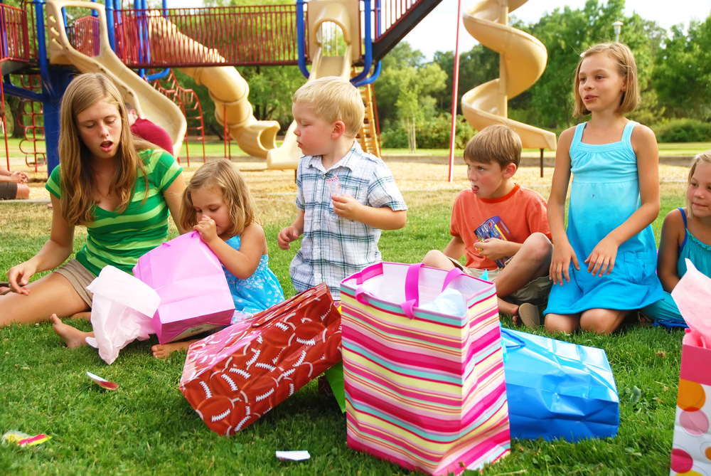 Group of children celebrate girl's birthday at a park