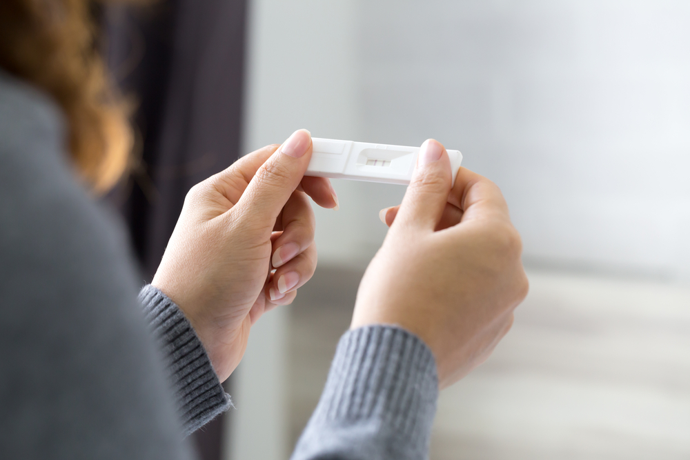 Woman holding pregnancy test, New life and new family concept.