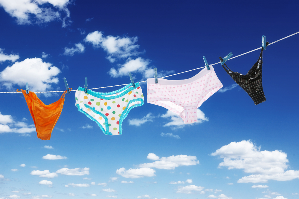 Panties hanging on clothesline in the blue sky