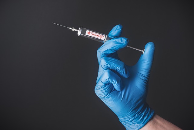 a hand holding a syringe