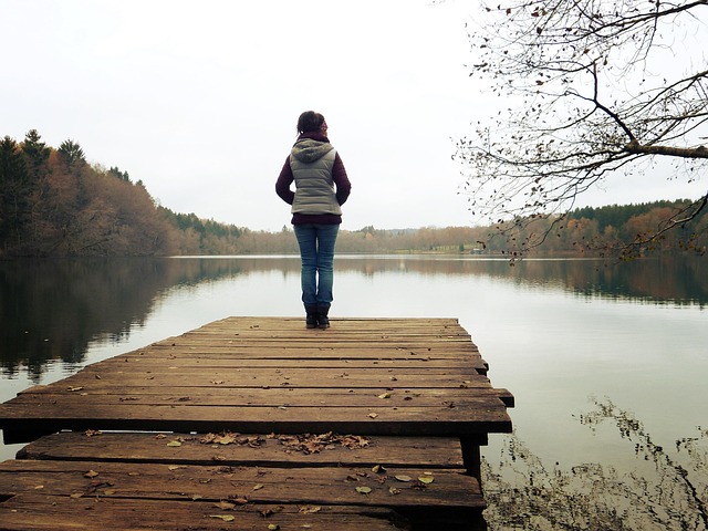 woman standing by a lake