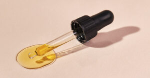 6 Plants You Didn’t Know Contain Cannabis-Like Compounds dropper filled with golden colored oil. Cannabis oil concept