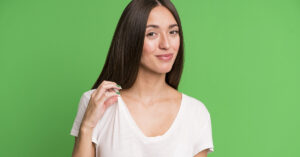 Think You’re ‘Arrogant’? It Might Just Be a Sign of Intelligence woman with smug look on face, green background