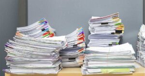 various stacked papers and documents