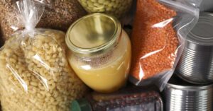 Man’s Front-Yard Food Pantry Gains Attention as Neighbors and Online Supporters Contribute Different food products as background, top view