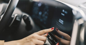 person using touchscreen interface in car