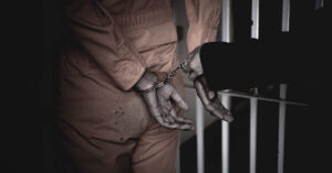 handcuffed woman in prison