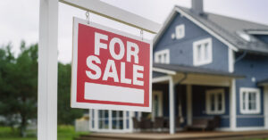 For Sale sign outside of home. Housing market concept