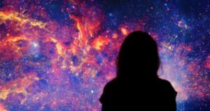 Nebulasexual: Understanding The Identity Where Desire Feels Distant Or Unfamiliar Dark silhouette of a girl in dress on mystical deep space background
