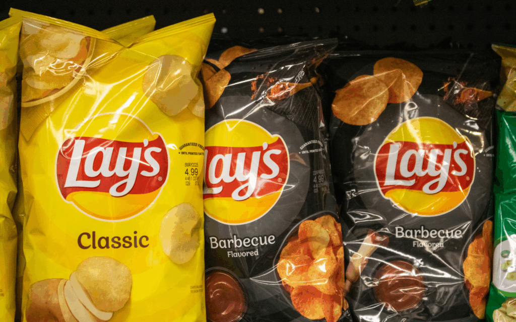 classic and barbeque flavoured Lay's chips on shelf